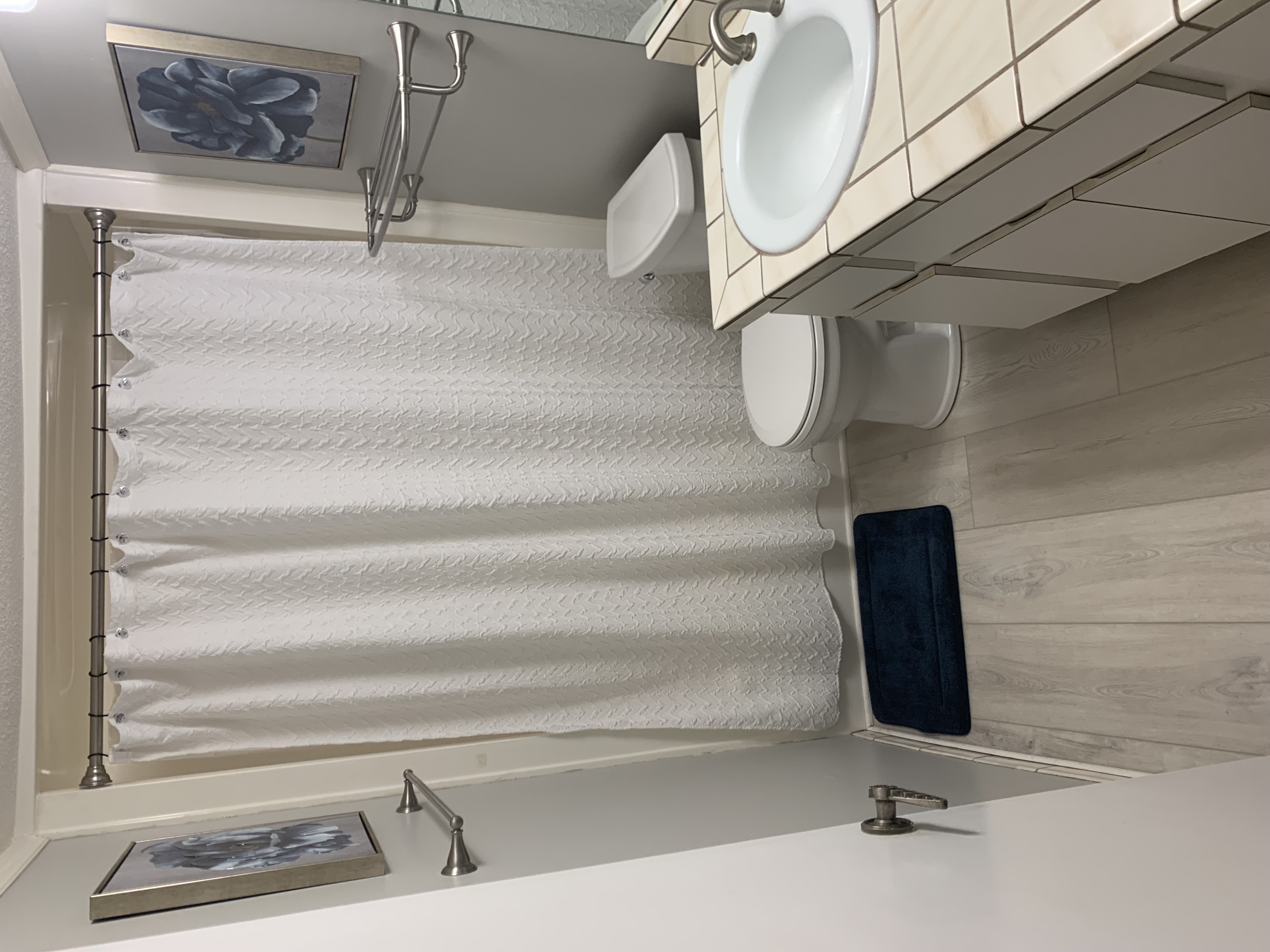 Bathroom with shower, vanity, and light wood floors