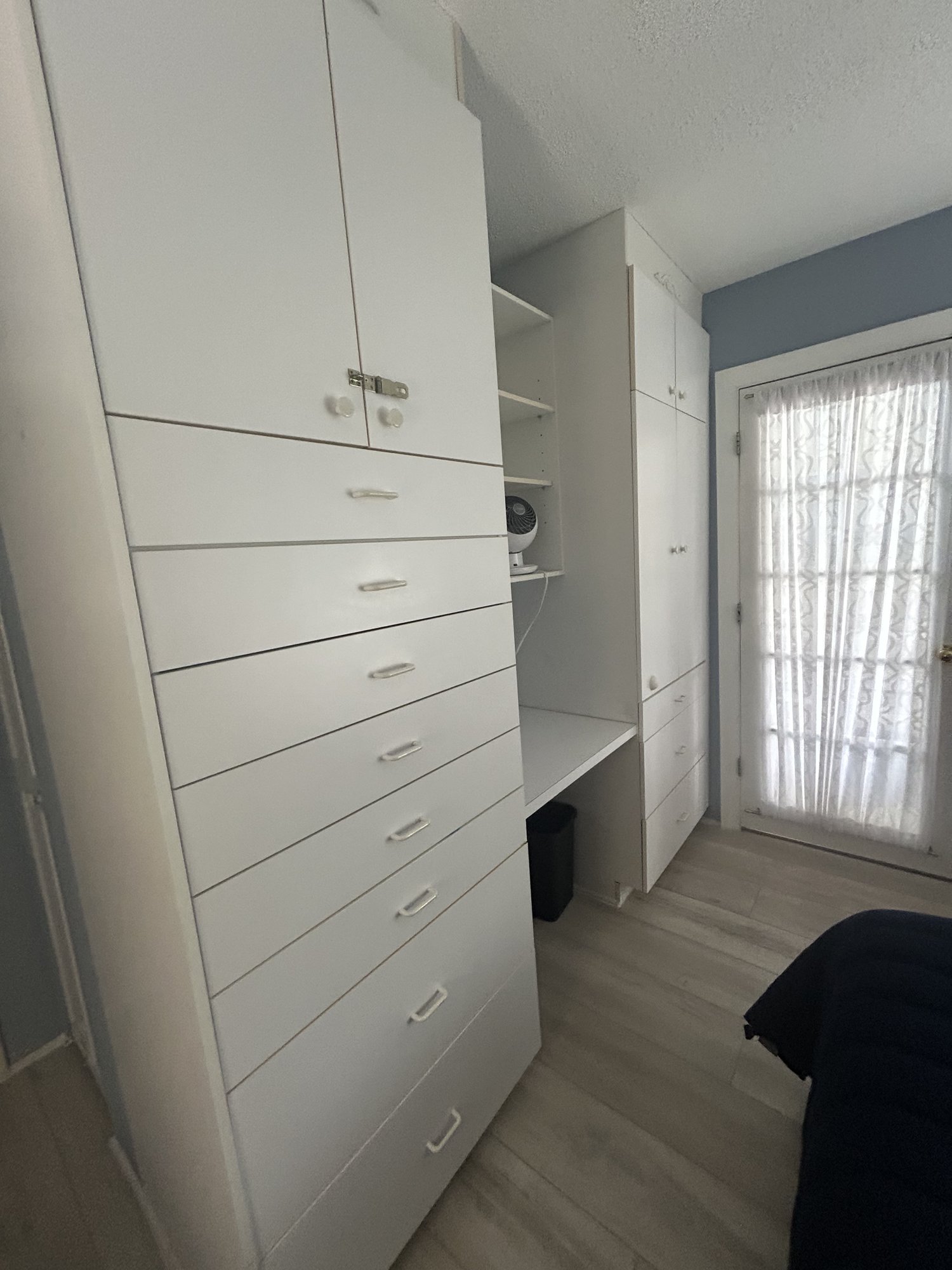 Second bedroom built-in drawers, closet, and French doors