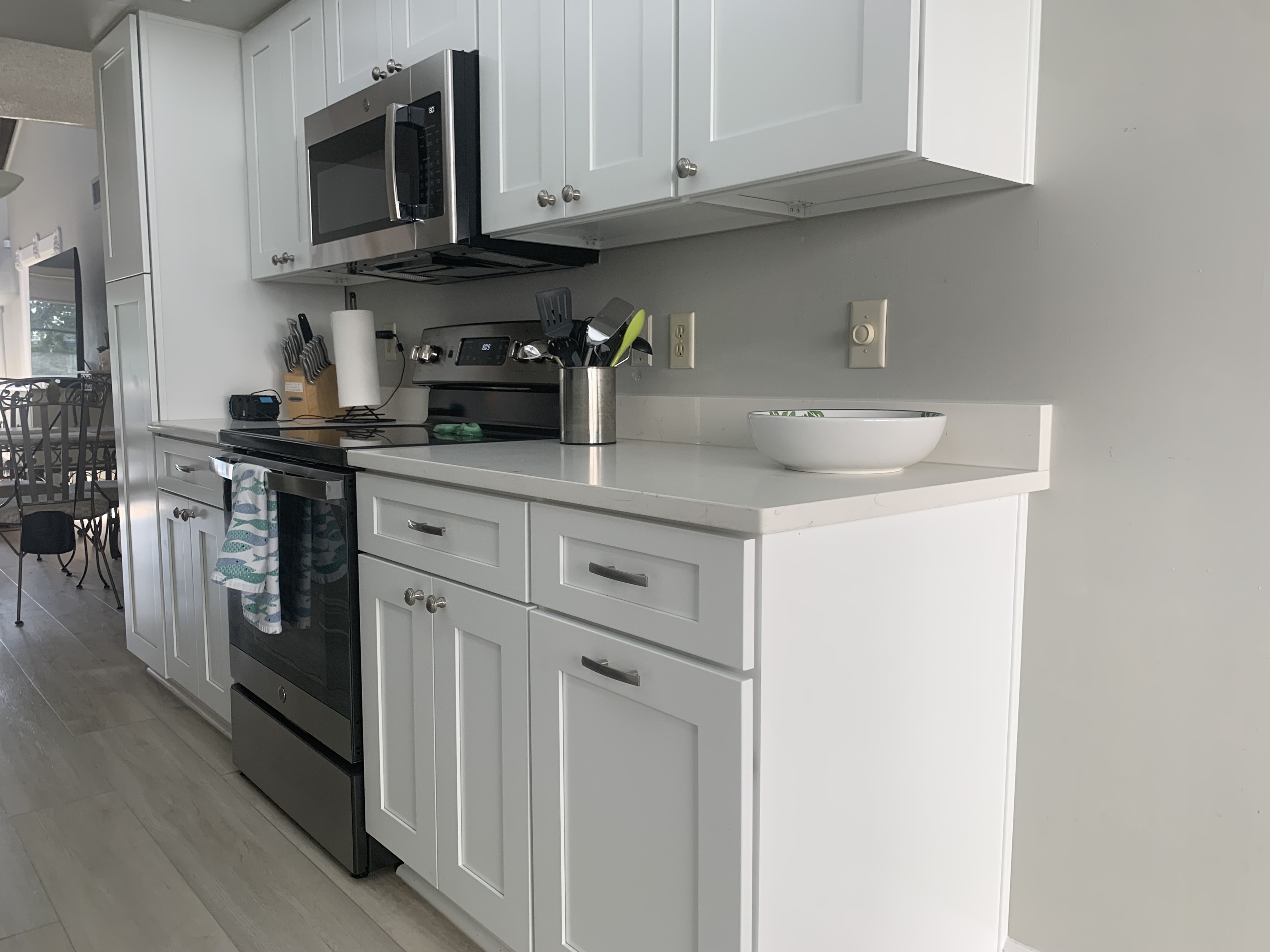 Kitchen range, microwave, and counters looking toward the living room