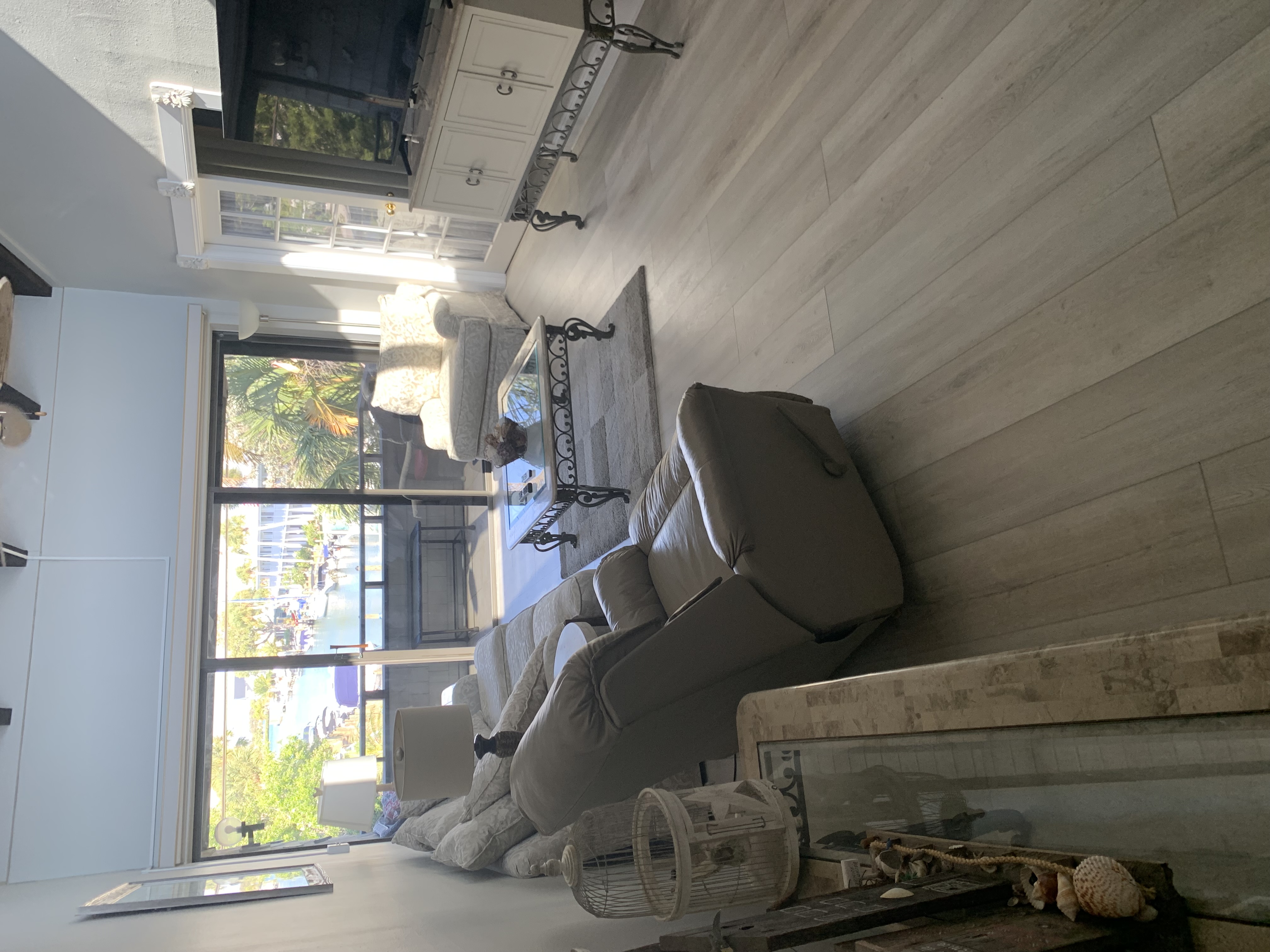 Living room with sliders opening to the canal and boats